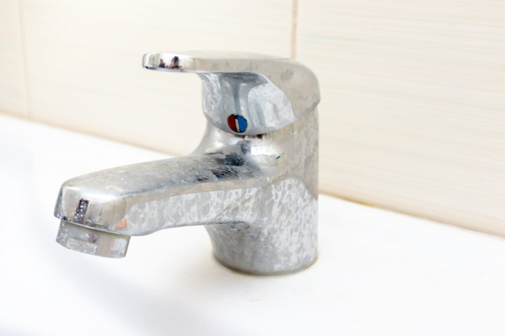 Dirty faucet with limescale, calcified water tap with lime scale Robertson Family Water